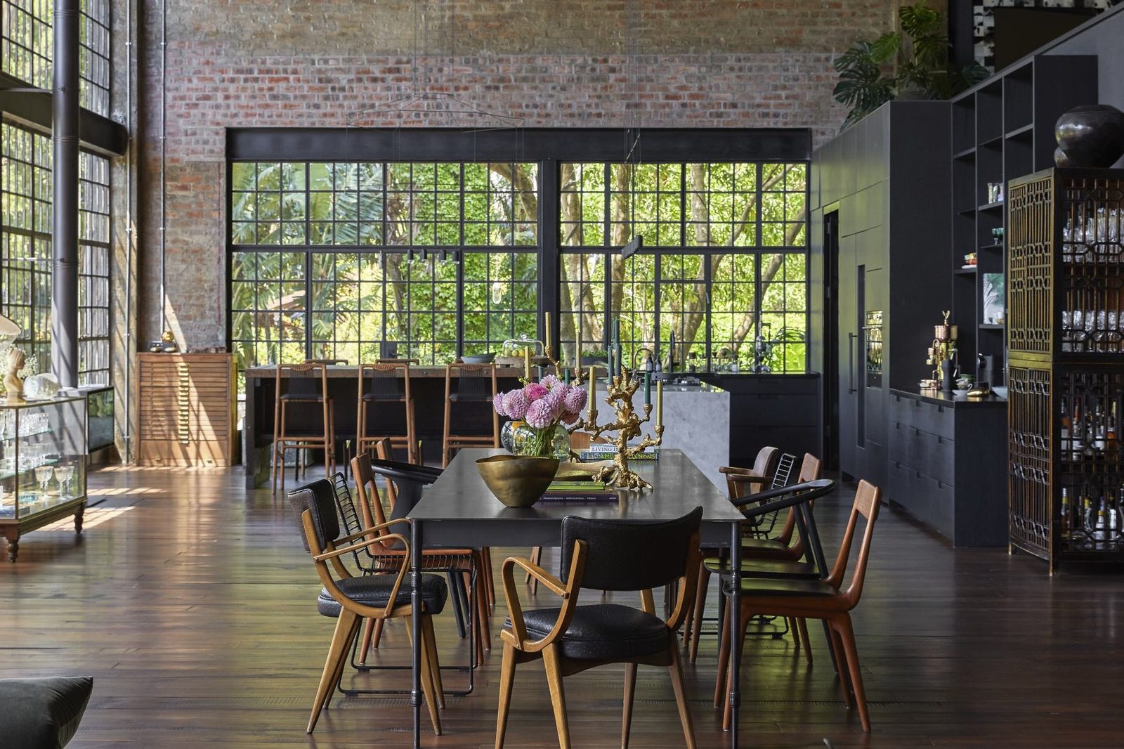Long dining table in the double height space